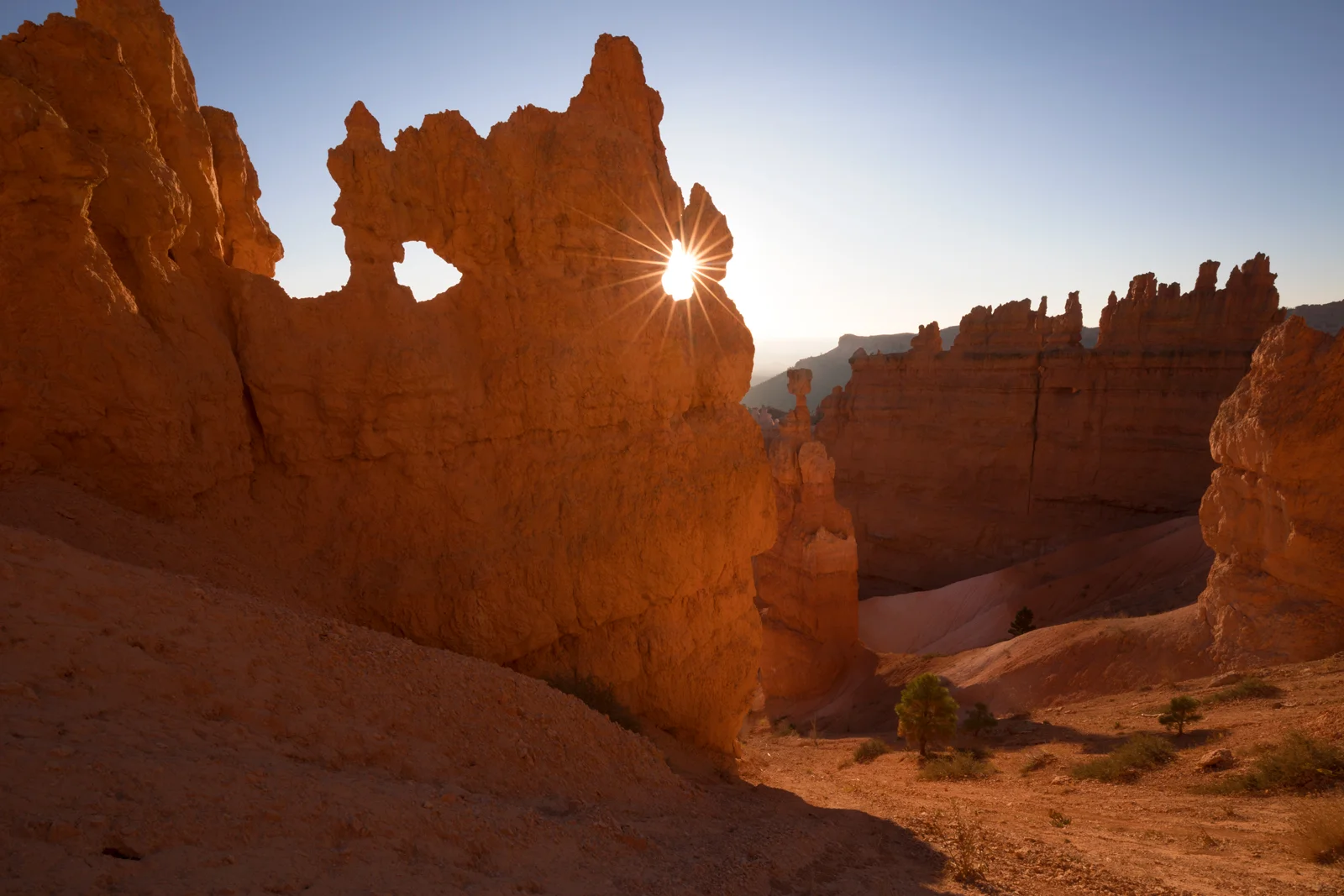 Sunlight bursting through a hoodoo arch at Bryce Canyon National Park