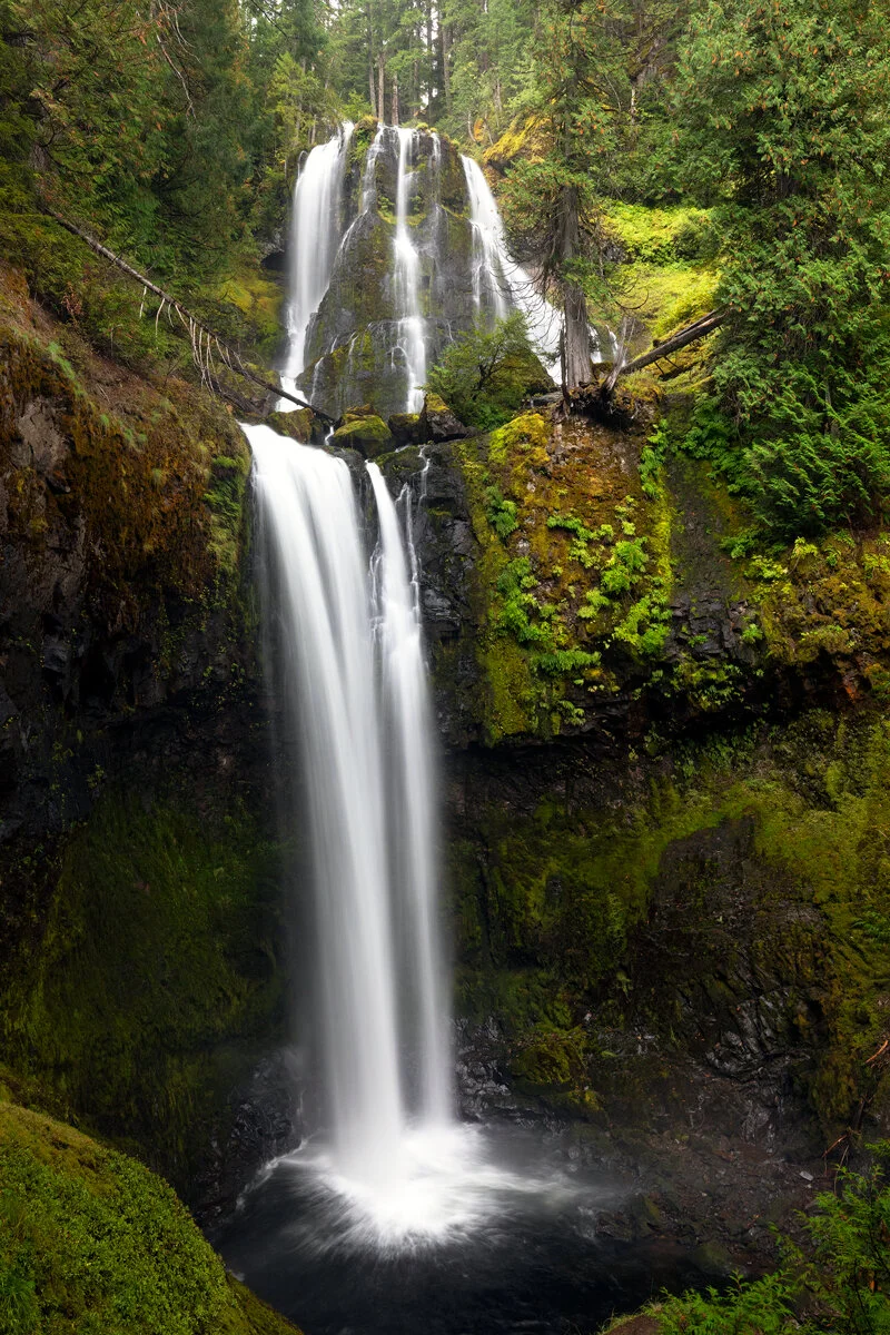 Fall Creek Falls tumbling in tiers through a lush green summer forest