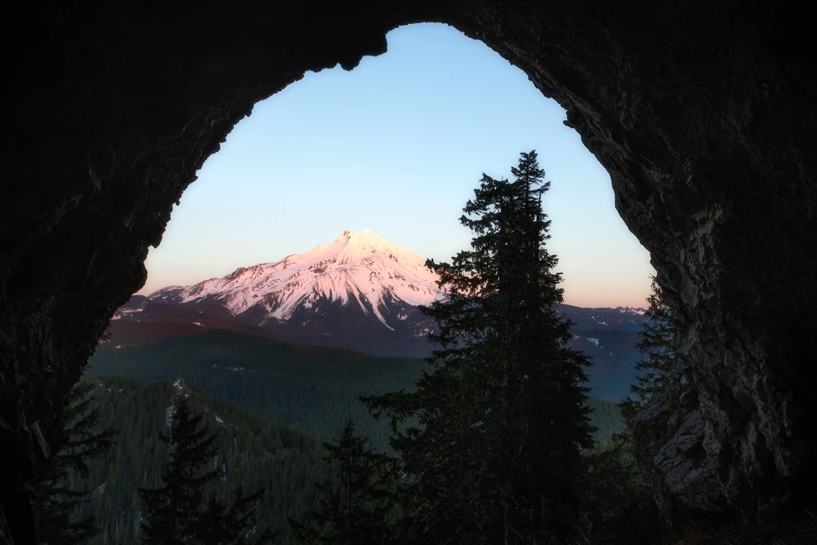 Mount Jefferson framed through a rock arch at sunset