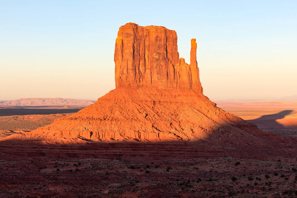 West Mitten Butte glowing orange in Monument Valley at sunset