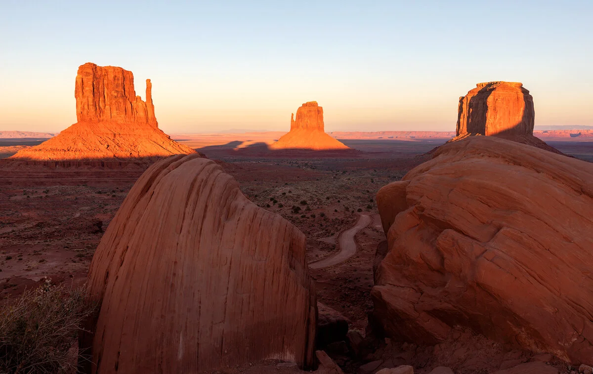 The Mittens buttes glowing at sunset in Monument Valley
