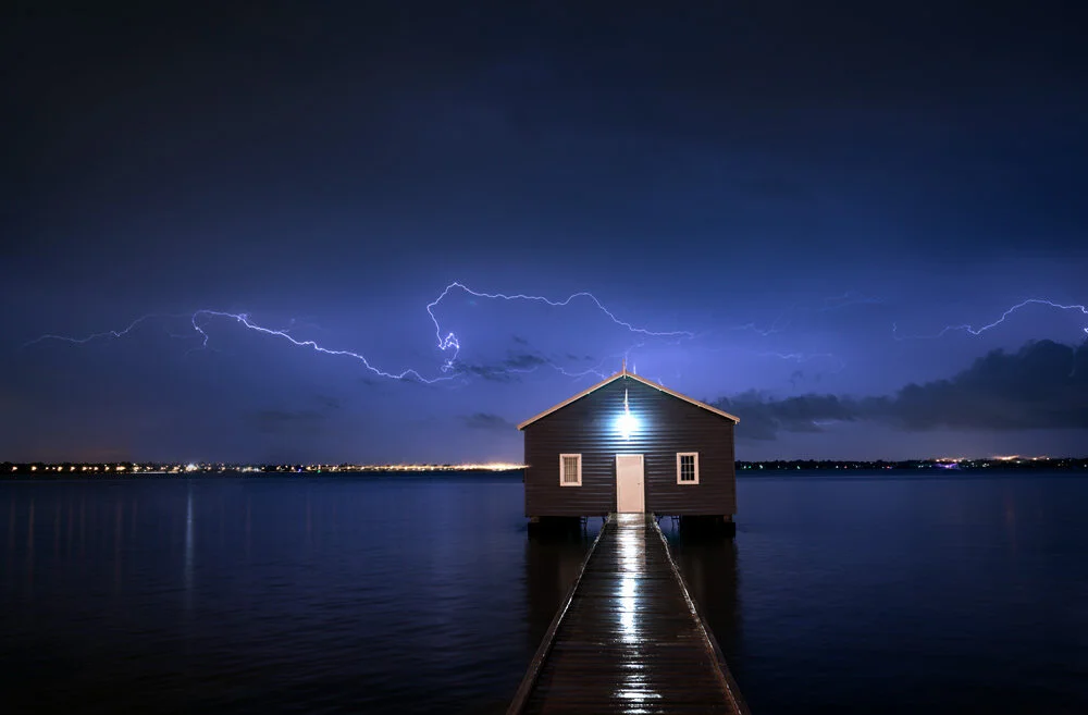 Perth's Crawley Edge Boatshed lit up beneath a lightning storm at night