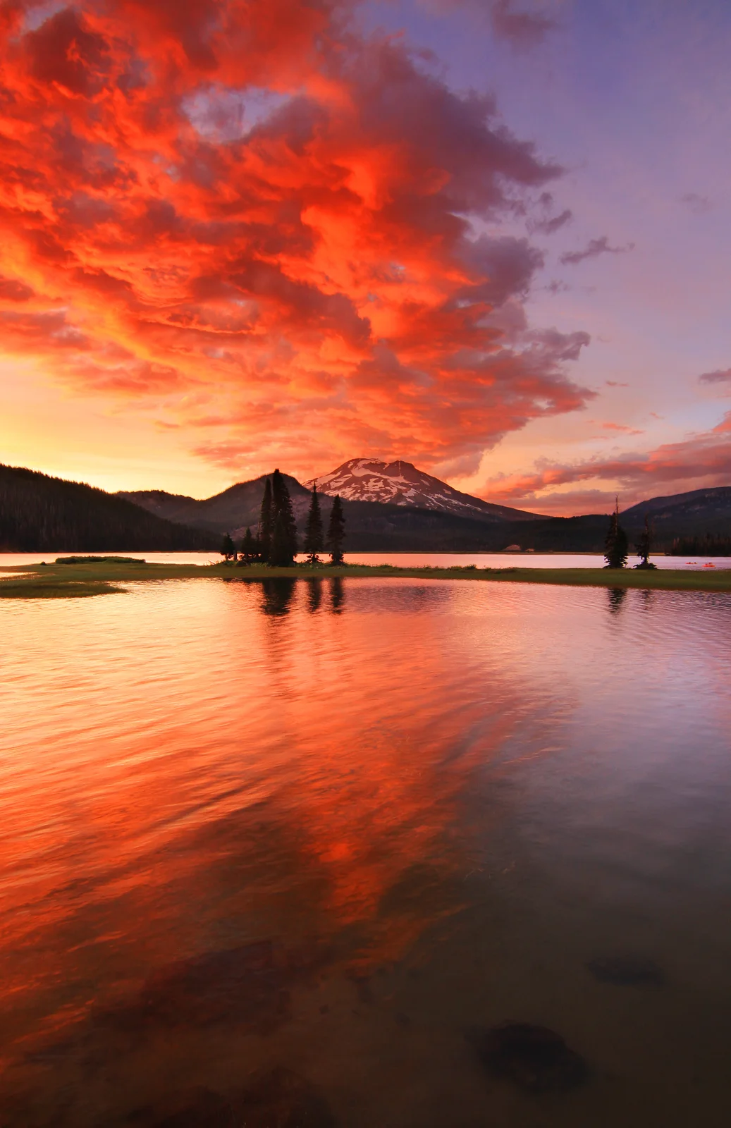 Sparks Lake ablaze with reflected color under a dramatic sunset sky