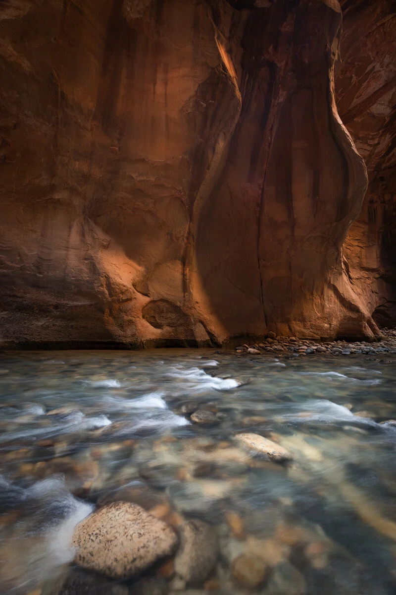 Virgin River flowing through the glowing sandstone walls of Zion Narrows